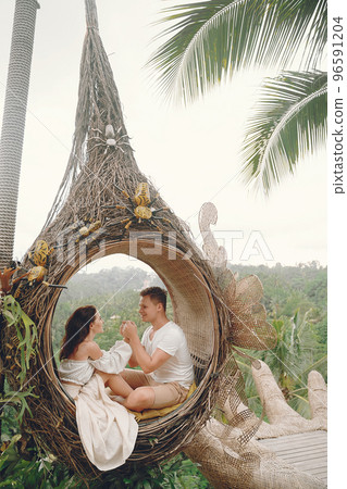 couple relaxing at an amazing beach club in Bali indonesia couple relaxing at an amazing beach club in Bali indonesia 96591204