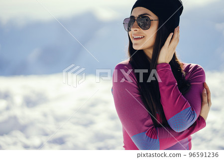young and stylish brunette in the snowy mountains young and stylish brunette in the snowy mountains 96591236