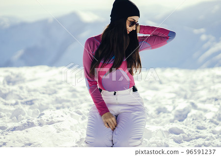 young and stylish brunette in the snowy mountains young and stylish brunette in the snowy mountains 96591237
