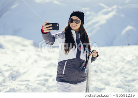 young and active brunette skiing in the snowy mountains young and active brunette skiing in the snowy mountains 96591239