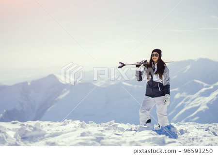 young and active brunette skiing in the snowy mountains 96591250