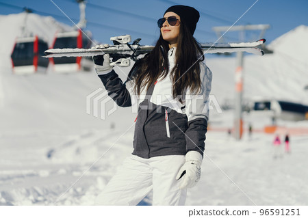 young and active brunette skiing in the snowy mountains 96591251