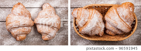 two croissants sprinkled with powdered sugar on old wooden board Top view two croissants sprinkled with powdered sugar on old wooden board Top view 96591945