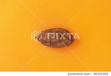 Baked sweet potato over orange background 96592992
