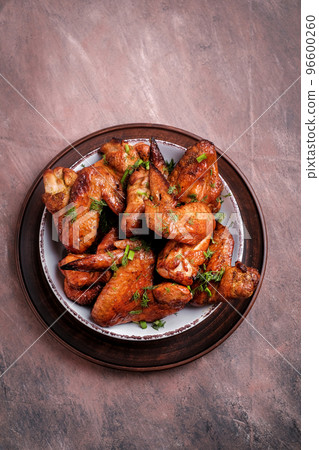 Barbecue chicken wings with sauce on  table. Top view. 96600260