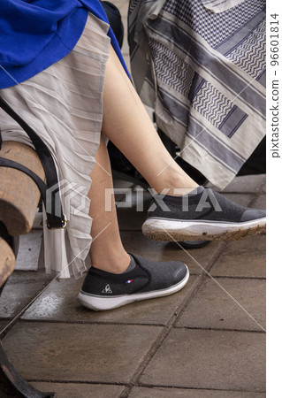 Feet of a woman relaxing on a bench 96601814