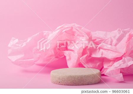 Minimalistic scene of a lying stone on a light pink abstract background. Minimalistic scene of a lying stone on a light pink abstract background. 96603061