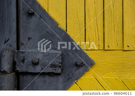 Background Wood Texture with black door hinge. Old yellow painted planks. 96604011