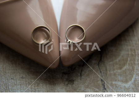 wedding engagement rings on the bride's shoes 96604012