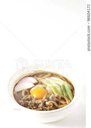Hot miso stewed udon with beef, shimeji mushrooms, green onion, kamaboko, and egg yolk shot against a white background Hot miso stewed udon with beef, shimeji mushrooms, green onion, kamaboko, and egg yolk shot against a white background 96604172