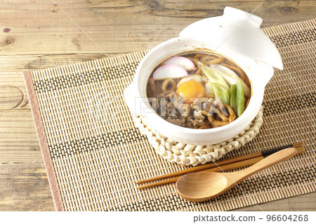 Hot miso stewed udon with beef, shimeji mushrooms, green onion, kamaboko, and egg yolk 96604268