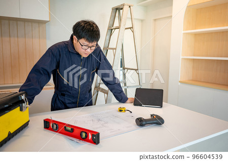 Interior manual worker working with construction tools Interior manual worker working with construction tools 96604539
