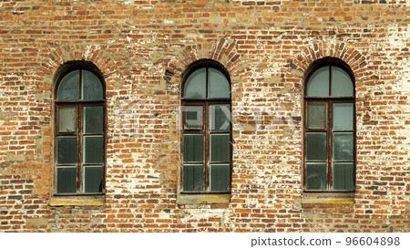Windows of a brick tower in the Gothic style 96604898