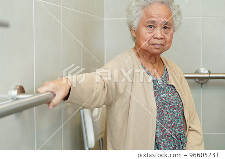 Asian elderly old woman patient use toilet support rail in bathroom, handrail safety grab bar, security in nursing hospital. Asian elderly old woman patient use toilet support rail in bathroom, handrail safety grab bar, security in nursing hospital. 96605231