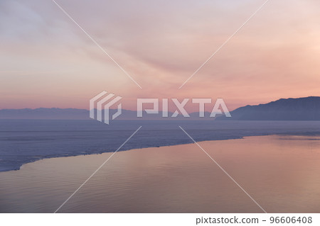 Beautiful sunset on frozen lake Baikal. Winter landscape. Beautiful sunset on frozen lake Baikal. Winter landscape. 96606408