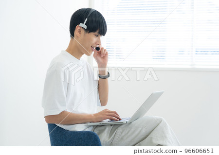A man who operates a personal computer 96606651