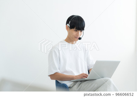 A man who operates a personal computer 96606652