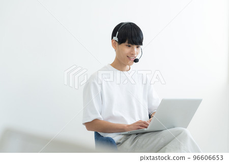 A man who operates a personal computer 96606653