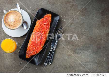 Traditional Spanish breakfast. Tostada with different toppings on a dark background. Top view with copy space Traditional Spanish breakfast. Tostada with different toppings on a dark background. Top view with copy space 96607373