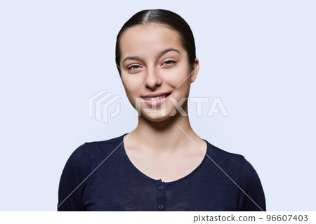 Portrait of teenager girl looking at camera on white background 96607403