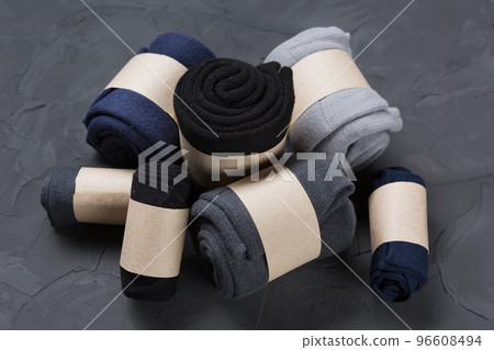 Pile of men's rolled up socks lies on concrete 96608494