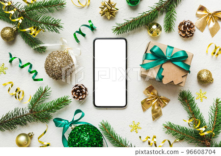Digital phone mock up with rustic Christmas decorations for app presentation top view with empty space for you design. Christmas online shopping concept. Tablet with copy space on colored background 96608704