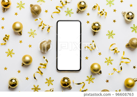 Christmas online shopping from home phone with blank white display top view. smart mobile with copy space on colored background with Christmas decorations balls,. Winter holidays sales background Christmas online shopping from home phone with blank white display top view. smart mobile with copy space on colored background with Christmas decorations balls,. Winter holidays sales background 96608763