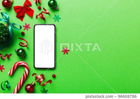 Digital phone mock up with rustic Christmas decorations for app presentation top view with empty space for you design. Christmas online shopping concept. Tablet with copy space on colored background Digital phone mock up with rustic Christmas decorations for app presentation top view with empty space for you design. Christmas online shopping concept. Tablet with copy space on colored background 96608786