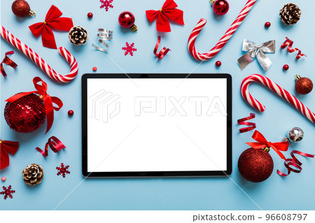 Top view of empty tablet on Christmas background made of new year decorand festive decorations. New year holiday concept. Mockup 96608797