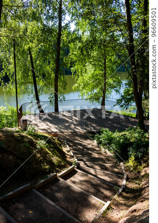 Descent from the slope along the steps to the observation deck on the shore of the reservoir, vertical view Descent from the slope along the steps to the observation deck on the shore of the reservoir, vertical view 96609501