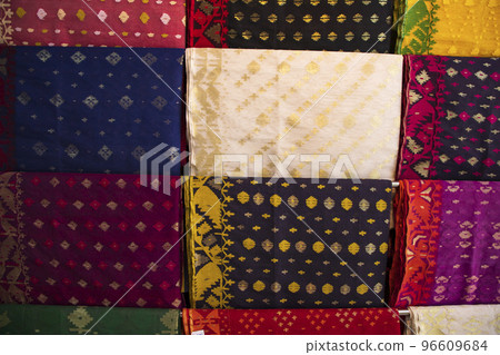 Bangladeshi Women,s Traditional Colorful Jamdani saree hanging in the retail Showrooms. Colorful Jamdani Saree Texture Background Bangladeshi Women,s Traditional Colorful Jamdani saree hanging in the retail Showrooms. Colorful Jamdani Saree Texture Background 96609684
