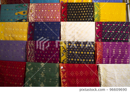Bangladeshi Women,s Traditional Colorful Jamdani saree hanging in the retail Showrooms. Colorful Jamdani Saree Texture Background Bangladeshi Women,s Traditional Colorful Jamdani saree hanging in the retail Showrooms. Colorful Jamdani Saree Texture Background 96609690