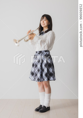 A high school girl with a trumpet 96609852