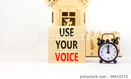 Use your voice symbol. Concept words Use your voice on wooden blocks on a beautiful white table white background. Black alarm clock. Business and use your voice concept. Copy space. Use your voice symbol. Concept words Use your voice on wooden blocks on a beautiful white table white background. Black alarm clock. Business and use your voice concept. Copy space. 96610370