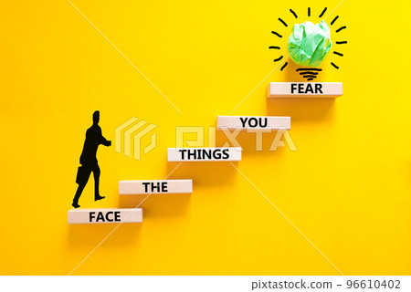 Face the things you fear symbol. Concept words Face the things you fear on wooden blocks on a beautiful yellow background. Businessman icon. Business and face the things you fear concept. Copy space. Face the things you fear symbol. Concept words Face the things you fear on wooden blocks on a beautiful yellow background. Businessman icon. Business and face the things you fear concept. Copy space. 96610402