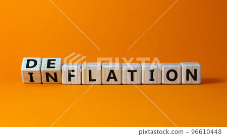Inflation or deflation symbol. Turned cubes and changed the word inflation to deflation. Beautiful orange background, copy space. Business, inflation or deflation concept. Inflation or deflation symbol. Turned cubes and changed the word inflation to deflation. Beautiful orange background, copy space. Business, inflation or deflation concept. 96610448