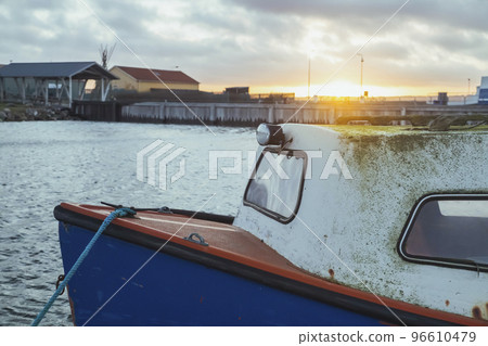 Old moss-covered boat at sunset in Denmark 96610479