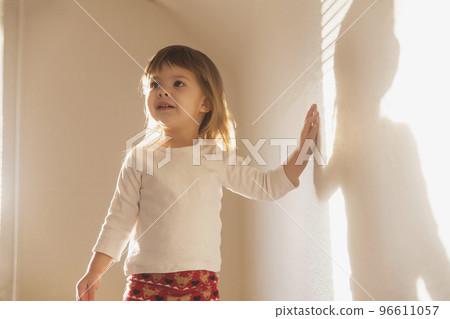 charming beautiful girl plays with her shadow 96611057