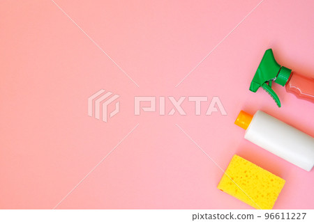 Cleaning products on pink background. Detergents and sponge. Housework and household concept. Top view. Copy space. 96611227