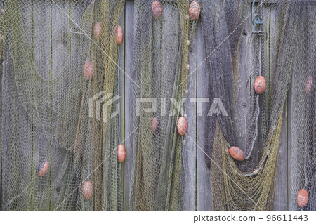 Old fishing net on a wooden fence. Background 96611443