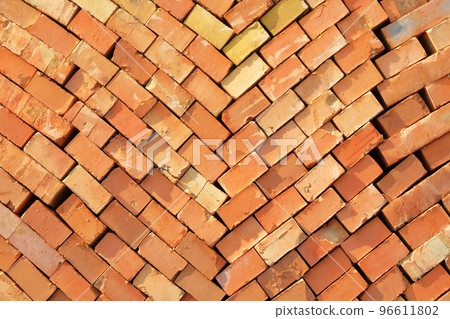Construction Materials. Pile of red bricks at construction site. Building stone for construction of buildings and structures, pattern. Close up. Construction Materials. Pile of red bricks at construction site. Building stone for construction of buildings and structures, pattern. Close up. 96611802