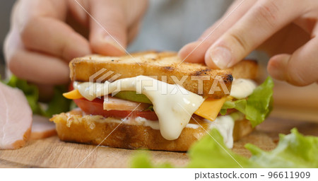 Making a sandwich with ham Making a sandwich with ham 96611909