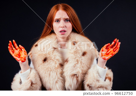sad redhaired ginger fashion victim woman with blood on her hands wearing natural fur coat and crying,studio black background.stop animal killing please sad redhaired ginger fashion victim woman with blood on her hands wearing natural fur coat and crying,studio black background.stop animal killing please 96612750