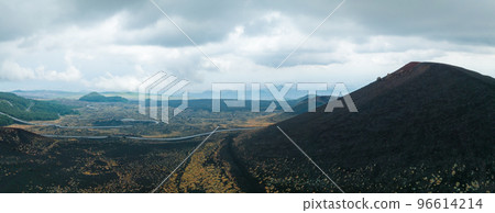 Panoramic aerial wide view of the active volcano Etna, extinct craters on the slope, traces of volcanic activity Panoramic aerial wide view of the active volcano Etna, extinct craters on the slope, traces of volcanic activity 96614214
