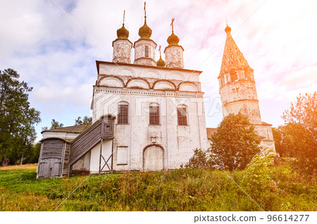 Old orthodox church at village. Summer view with floral meadow. Sun flare Old orthodox church at village. Summer view with floral meadow. Sun flare 96614277