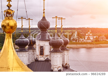 Eastern orthodox crosses on gold domes, cupolas, against blue sky with clouds 96614289