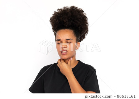 Portrait of displeased young woman touching neck 96615161