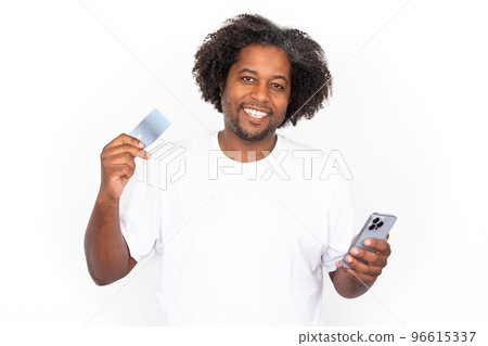 Happy African American man using phone and credit card Happy African American man using phone and credit card 96615337