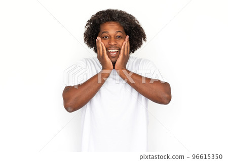 Surprised African American man pressing hand to cheeks Surprised African American man pressing hand to cheeks 96615350