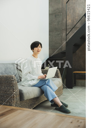 A woman looking at a computer A woman looking at a computer 96615421